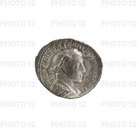 Denarius, Roman deities; Jupiter; Alexander Severus Roman emperor, 222–235 — iconography. Obverse: IMPCMAVRSEVALEXANDAVG. Bust of Alexander Severus with laurel wreath and paludamentum facing right; pearl rim. Reverse: PM TRPII COSPP. Jupiter naked in a cloak stands facing left, holding a thunderbolt in his right hand and a long scepter in his left; pearl rim. 223 CE, Roman Empire; mint: Rome. Coin; diameter 17.0–19.5 mm; weight 3.02 g., A round metallic object with a worn, textured surface showing a raised profile of a person facing right, surrounded by a raised rim and subtle decorative elements, primarily in shades of gray and silver with darker gray patina and lighter silvery highlights.
