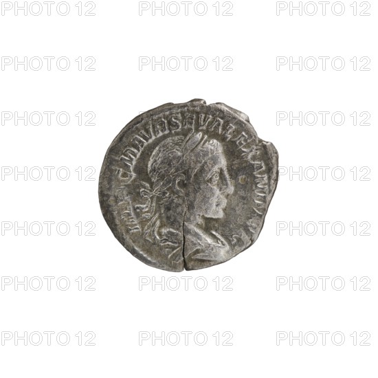 Denarius, Alexander Severus 208–235; Roman emperor 222–235. Obverse: Bust of Alexander Severus with laurel wreath and paludamentum facing right, pearl rim. Inscription: IMPCMAVRSEVALEXANDAVG. Reverse: Pax standing left, holding an olive branch in her right hand and a scepter in her left, pearl rim. Inscription: PMTR PII COSPP. 223 CE. Roman Empire, Rome. Coin; diameter 18.0–19.0 mm; weight 2.45 g., A worn circular metal coin with a gray and dark gray patina showing a raised profile of a person's head facing right; the head has short hair and a tied ribbon at the back, and the coin surface shows scratches, chips, and a visible crack toward the bottom.