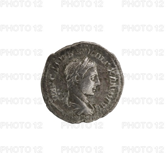 Denarius; Roman deities; Jupiter; Alexander Severus Roman emperor, 222–235 — iconography. Obv.: IMPCMAVRSEVALEXANDAVG. Head of Alexander Severus right, laurel wreath and paludamentum, pearl rim. Rev.: IOVI VL TORI. Jupiter half-naked, seated on a throne facing left, holding Victoria in his outstretched right hand and a spear in his left, pearl rim. 222–228. Coin. Diameter 18.5–19.5 mm; weight 2.88 g., A round metal coin with a worn, rough edge showing a raised profile of a person facing right; the figure has short textured hair and a draped garment visible at the shoulder. The coin surface is textured with irregularities and faint raised markings around the rim that form a circular border. The colors visible are dark gray, silver-gray, and hints of brownish-gray.