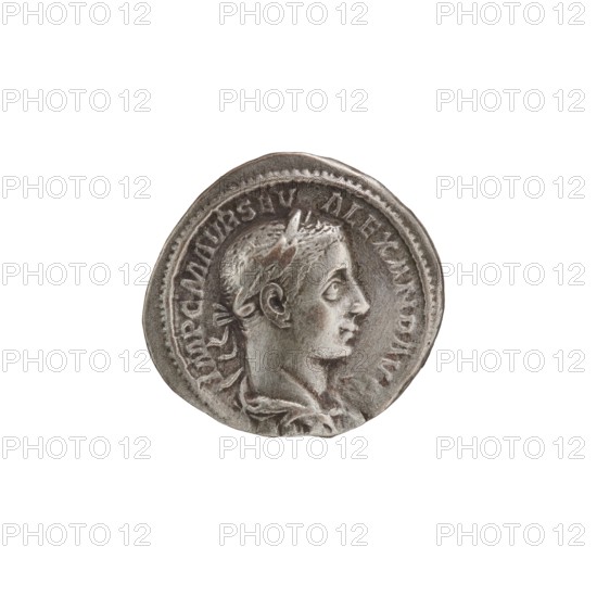 Denarius, Roman, 222–228 CE. Obverse: Head of Alexander Severus right, laurel wreath, pearl rim; inscription IMPCMAVRSEVALEXANDAVG. Reverse: Jupiter half-naked, seated on a throne facing left, holding Victoria in his outstretched right hand and a spear in his left; pearl rim; inscription IOVI VL TORI. Minted in Rome. Silver coin; diameter ~18.5–19.0 mm; weight 2.95 g., A circular metallic object with a raised profile of a person in classical style facing right, showing detailed facial features, hair, and a laurel or headband; the surface has worn and textured areas and a raised rim; colors visible include silver, gray, and darker gray tones.