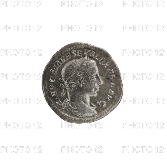 Denarius, Alexander Severus Roman emperor; 222–235 — Obv.: IMPCMAVRSEVALEXANDAVG. Bust of Alexander Severus with laurel wreath and paludamentum facing right, pearl rim. Rev.: VIRT VSAVG. Virtus in military garb and helmet facing right, holding a spear point down in his right hand, resting his left on a shield at his feet, pearl rim. 222–228. Roman Empire. Rome. Coin; diameter 18.5–19.5 mm; weight 3.30 g., A round metallic object with a worn, textured surface showing a raised profile of a person's head facing right, including visible hair, ear, nose, and neck, surrounded by a raised rim and a ring of indistinct raised markings; the object is mainly shades of gray and silver with darker gray shadows and lighter highlights, set against a plain white background.