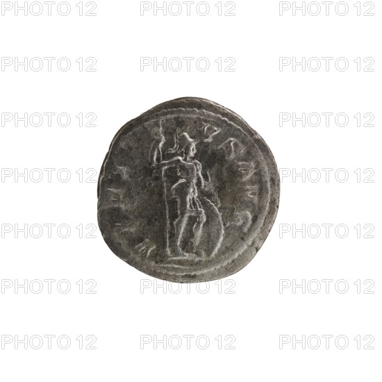 Denarius, Alexander Severus Roman emperor; 222–235 — iconography: personifications, Virtus. Obverse: IMPCMAVRSEVALEXANDAVG. Bust of Alexander Severus with laurel wreath and paludamentum facing right; pearl rim. Reverse: VIRTVSAVG. Virtus in military garb and helmet facing right, holding a spear point down in his right hand, resting his left on a shield at his feet; pearl rim. Date: 222–228. Roman Empire. Place of mint: Rome. Object type: coin. Diameter: 18.5–19.5 mm. Weight: 3.30 g., A round, worn metallic object with a dark gray and silvery surface showing a raised, weathered figure in profile standing on a textured base; the figure appears to be wearing a short skirt-like garment and holds a long vertical object, with faint curved borders and irregular surface scratches and indentations visible across the object.