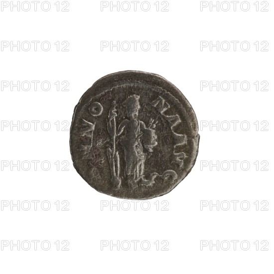 Denarius, personifications, Annona personification, Alexander Severus Roman emperor; 222–235 — iconography. Obv.: IMPSEVALE XANDAVG Head of Alexander Severus right, wearing a laurel wreath, pearl rim. Rev.: ANNO NAAVG Annona stands turned right, resting her left leg on the bow of a ship, holding a rudder on a ball in her right hand and a modius with ears of corn in her left, pearl rim. 228–231. Roman Empire. Rome. Coin. Diameter 18.5–19.0 mm. Weight 2.85 g., A round, worn metal coin with a dark gray and brown patina shows a raised central figure standing and holding a long staff in one hand and a smaller object in the other; the figure appears draped in a robe and wears a headpiece. The coin edge is irregular and slightly raised, with areas of lighter gray highlighting the relief. The background around the coin is plain white.