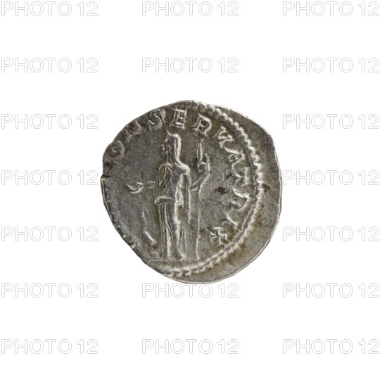 Denarius depicting Julia Mamaea ca. 180–235; Augusta 222–235 and Alexander Severus 208–235; Roman emperor 222–235. Obverse: busts/portraits of Julia Mamaea and Alexander Severus; reverse: Juno Roman deity. Iconography of Julia Mamaea 180–235. Date: 225–235. Place: Rome, Roman Empire 27 BC–476. Medium: coin. Dimensions: diameter ~18.5–19.0 mm; weight 2.93 g., A round metallic object with a worn, uneven edge sits against a white background; the object is primarily silver-gray with darker gray areas and small brownish spots, and it shows a raised, embossed design featuring a vertical figure-like shape flanked by other carved elements and surrounded by a beaded border.