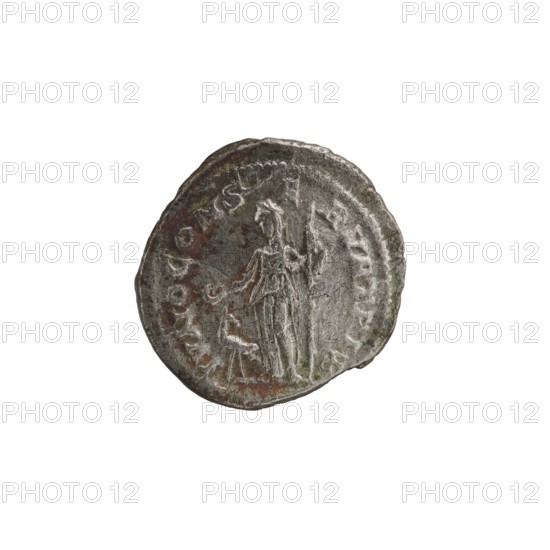 Denarius depicting Julia Mamaea ca. 180–235; Augusta 222–235 and Alexander Severus 208–235; Roman emperor 222–235, issuer; obverse/title inscriptions and imperial titles; reverse: Juno Roman deity iconography. Date: 225–235 CE. Place of creation: Rome, Roman Empire. Medium/format: coin; diameter ~19–20 mm; weight 2.86 g., A round metallic object with a worn, uneven edge showing a few irregularities; its surface is mottled with shades of gray, dark brown, and hints of green. The face shows a raised, faintly detailed figure standing, with elongated vertical lines suggesting draped clothing and a few subtle contours indicating limbs and a head. Around the perimeter there is a shallow raised border with irregular impressions and worn areas. The overall texture appears rough and pitted with small patches of darker discoloration and lighter highlights where the metal catches light.