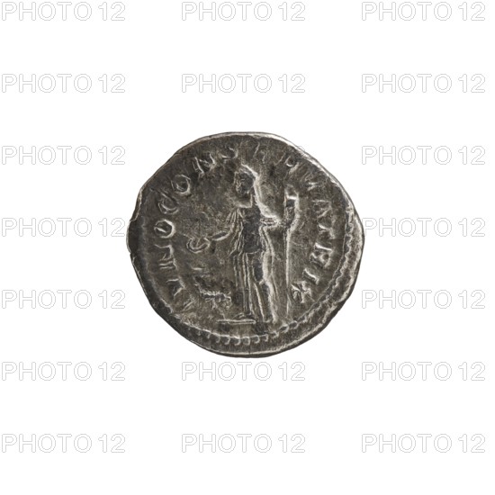 Denarius depicting Julia Mamaea ca. 180–235; Augusta 222–235 and Alexander Severus 208–235; Roman emperor 222–235; obverse: portrait/inscription identifying rulers; reverse: Juno myth., Roman deity. Iconography of Julia Mamaea 180–235. Date ca. 225–235 CE, Roman Empire, Rome. Coin denarius; diameter ~17–19 mm, weight 1.69 g., A round metallic coin with a worn, textured surface showing a raised central figure standing and facing sideways, with a draped garment and an extended arm; faint decorative edging runs around the rim and there are several raised shapes and markings around the figure. The visible colors are silvery gray with darker gray shadows and lighter gray highlights.