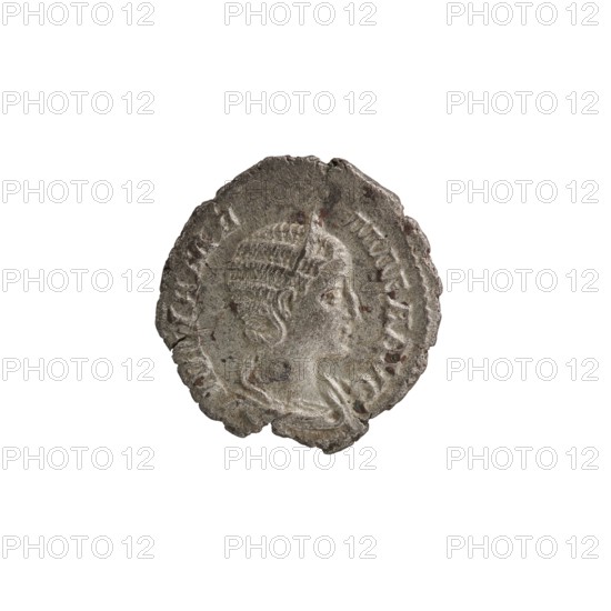 Denarius depicting Julia Mamaea ca. 180–235; Augusta 222–235 and Alexander Severus 208–235; Roman emperor 222–235. Obverse/issuer: Alexander Severus; features Roman deities—Vesta; iconography of Julia Mamaea 180–235. Date: 225–235. Place of origin: Rome, Roman Empire 27 BC–476. Object type: coin denarius. Measurements: diameter 19.5–20.0 mm; weight 2.70 g., A worn round metallic object with an irregular edge, showing a raised profile of a person's head facing right with detailed hair and facial features; the surface has areas of discoloration and small dark spots. The visible colors include gray, silver, dark brown, and hints of reddish-brown.