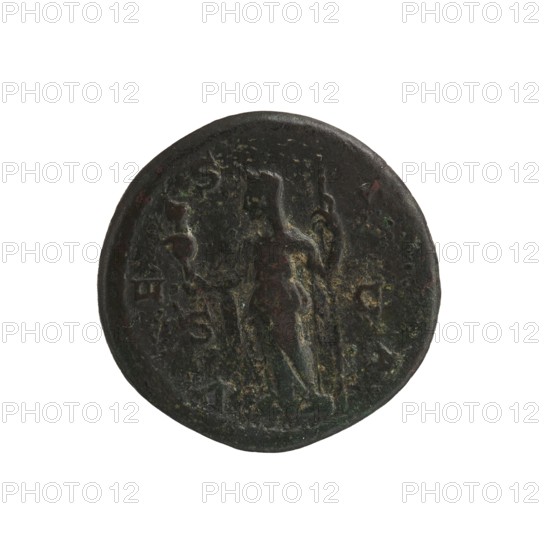 Julia Mamaea ca. 180–235; Augusta 222–235, Alexander Severus 208–235; Roman emperor 222–235, Roman deities — Vesta; Julia Mamaea — iconography; dated 225–235, Rome; Roman Empire 27 BC–476; coin; diameter 24.0–25.0 mm; weight 9.73 g, A circular dark coin-like object with a worn surface showing a raised central figure in relief, flanked by faint shapes and marks; the object displays a patina with visible colors including dark brown, green, and hints of reddish tones, with areas of lighter greenish and yellowish corrosion along the raised details and rim.