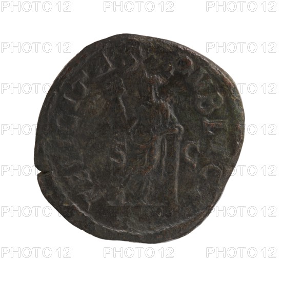 Sestertius depicting Julia Mamaea ca. 180–235 and Alexander Severus 208–235; Roman emperor 222–235, issuer Alexander Severus; obverse/personifications: Julia Mamaea — iconography; reverse: Felicitas personification. Date: 225–235. Place of creation: Rome, Roman Empire 27 BC–476. Coin; diameter 29.0–29.5 mm; weight 18.2 g., A round, irregularly shaped dark coin with a worn surface showing a faint raised profile of a person on one side and a standing figure on the opposite side; the coin displays a rough texture with visible wear and small nicks around the edge, and colors include dark brown, black, with hints of greenish and reddish tones.