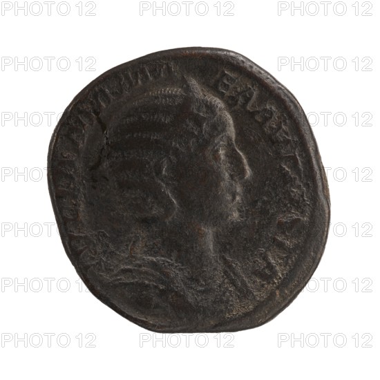 Sestertius of Julia Mamaea and Alexander Severus, 225–235 CE. Bronze coin diam. ~29–30 mm, weight 23.5 g. Obverse: Julia Mamaea ca. 180–235 and titles; issuer Alexander Severus 208–235, Roman emperor 222–235. Reverse: personification Felicitas. Roman Empire; Rome mint., A dark, round coin with an aged, textured surface showing a raised profile of a person facing right; the coin appears mostly dark brown and black with some lighter brown highlights and subtle reddish-brown spots; the rim is slightly irregular and the portrait shows hair detail and the suggestion of shoulders against a plain background.