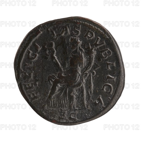 sestertius; issuer: Alexander Severus 208–235, Roman emperor 222–235; co-creator: Julia Mamaea ca. 180–235; Augustus 222–235; obverse/personification: Felicitas; iconography includes Julia Mamaea 180–235; date: 222–235; place of creation: Rome, Roman Empire 27 BC–476; object type: coin; material: sestertius; diameters: 29.5 mm, 32.0 mm; weight: 18.3 g, A round dark coin with a worn surface showing a raised central figure seated on a throne; the figure and surrounding reliefs are in dark brown and black tones with some lighter worn highlights, and the coin edge is slightly irregular in shape with a few shallow dents.