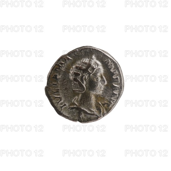 Denarius depicting Julia Mamaea ca. 180–235; Augusta 222–235 and Alexander Severus 208–235; Roman emperor 222–235; obverse/inscription references to ruler, titles, and hierarchy of power; imagery includes Juno myth. and Roman deities; iconography of Julia Mamaea 180–235, dated 225–235, Roman Empire 27 BC–476, Rome; coin; diameter 18.5–19.5 mm; weight 3.32 g., A round metal coin shown against a white background with a raised profile of a person facing right; the coin surface shows wear and texture with areas of darker and lighter metallic tones including silver, gray, brown, and hints of greenish patina; the portrait displays detailed hair and facial contours and the rim of the coin is irregular with a few notches.