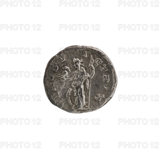 Denarius; obverse: portrait of Julia Mamaea ca. 180–235 with inscriptions naming titles/positions; reverse: depiction of Venus; issuer: Alexander Severus 208–235; Roman emperor 222–235; iconography: Julia Mamaea; date: 225–235; place of creation: Rome, Roman Empire 27 BC–476; material: coin; diameter: 17.0–18.0 mm; weight: 2.90 g., A round metal coin with a worn surface showing a raised relief of a standing human figure holding a long staff in one hand and making a gesture with the other; the figure appears clothed in draped garments and is centered on the coin. The coin's edge is irregular and shows small dents and wear. The surface texture is rough with areas of lighter and darker metallic sheen. The visible colors are shades of gray and silver with darker gray shadows and slightly lighter highlights. The background around the coin is plain white.