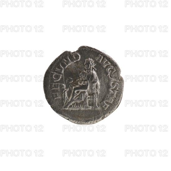Denarius of Alexander Severus reigned 222–235 CE. Obverse: laureate/diademed bust of Alexander Severus emperor 222–235. Co-issuer: Julia Mamaea Augusta, ca. 180–235. Reverse: Fecunditas personification. Iconography associated with Julia Mamaea. Date: c. 225–235 CE. Origin: Rome, Roman Empire. Material/object type: coin denarius. Diameter: 18.0–19.0 mm. Weight: 1.95 g., A round, worn metallic coin with a dark gray surface and lighter gray highlights showing raised and recessed areas; the coin displays the faint, embossed outline of a seated figure facing sideways and another standing figure nearby, with textured details suggesting clothing and a chair; the edges are irregular and slightly chipped, and the overall color palette includes dark gray, light gray, and small patches of brownish discoloration.