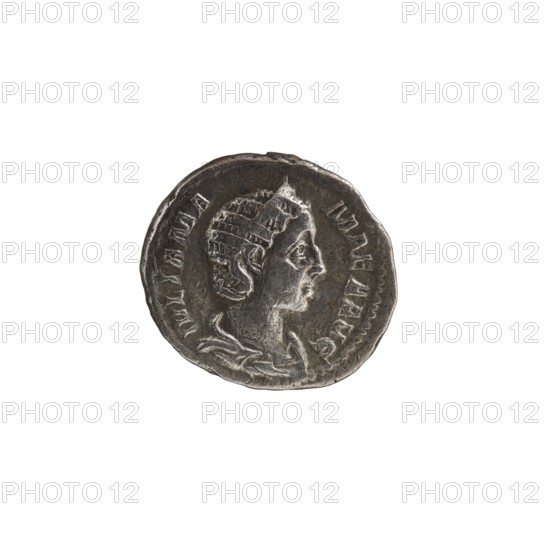 Denarius of Julia Mamaea ca. 180–235; Augusta 222–235 and Alexander Severus 208–235; Roman emperor 222–235, issuer; obverse/personifications: Julia Mamaea 180–235 — iconography; reverse: Fecunditas personification; dated 225–235, Roman Empire 27 BC–476, Rome; coin; diameter 17.0–19.0 mm; weight 2.70 g., A round metallic coin with a worn, uneven edge showing a raised profile of a person facing right, wearing a detailed headdress and draped clothing; the surface shows textured wear and shallow relief markings around the portrait; visible colors include shades of silver, gray, and dark gray against a white background.