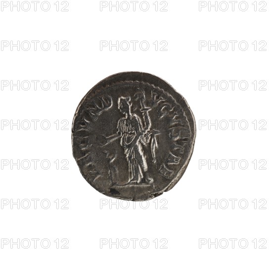 Denarius depicting Julia Mamaea ca. 180–235; Augusta 222–235 and Alexander Severus 208–235; Roman emperor 222–235. Obverse: issuer/author Alexander Severus; reverse: Fecunditas personification. Personifications; iconography of Julia Mamaea 180–235. Date: 225–235. Place: Rome, Roman Empire 27 BC–476. Coin; diameter 19.0 mm and 18.5 mm; weight 3.20 g., A round metallic object sits centered on a plain white background, appearing dark gray with lighter silvery highlights on raised areas; the surface shows worn texture and uneven edges. The object bears the relief of a standing human figure in draped clothing holding an object, with the figure slightly off-center and facing sideways. A ring of raised decorative elements encircles the figure, and there are irregular chips and scratches along the perimeter. The overall colors visible are dark gray, light gray, and white.