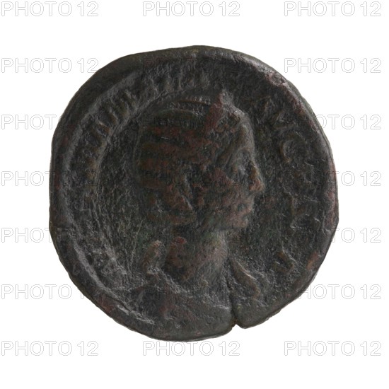 Sestertius depicting Julia Mamaea ca. 180–235 and Alexander Severus 208–235; Roman emperor 222–235. Obverse: portrait/inscription of Alexander Severus with imperial titles; reverse: Fecunditas personification. Iconography of Julia Mamaea 180–235. Roman Empire, Rome, ca. 222–235. Coin sestertius; diameter 26.5–28.5 mm; weight 23.45 g., A circular, worn metal coin with a raised profile of a person facing right, showing facial features and hair in low relief; the surface is rough and pitted with irregular edges and a small notch on the rim; the coin displays dark brown, green, and black tones with hints of reddish-brown patina across its face.