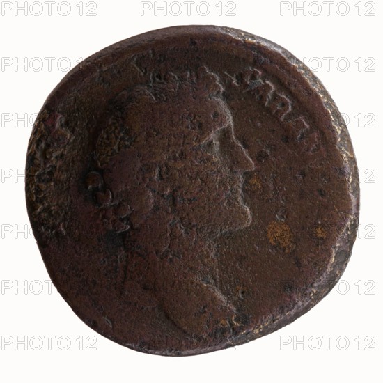 Sestertius, Hadrian 76–138; Roman emperor 117–138 as issuer; Antoninus Pius 86–161; Roman emperor 138–161, caesar 138 — personifications; sacrifice; Pietas standing before an altar; altars. Obverse: Head of Antoninus Pius bare, facing right, legend IMP T AELIVS CAE - SAR ANTONINVS. Reverse: Pietas stands left before an altar, making an offering with his right hand and holding a container of perfumes in his left, legend TRIB POT COS DES II, episode PIETAS. Date: 138. Place of origin: Rome, Roman Empire. Object: coin sestertius. Diameter: 29.5–30.0 mm. Weight: 26.32 g. Axis: 180°., A round, worn metal coin with a raised profile of a person facing right; the surface shows rough, pitted texture and areas of corrosion. The coin displays dark brown and reddish-brown tones with patches of lighter brown and small spots of yellowish-orange. The rim is uneven and slightly raised in places, and the details of the portrait and surrounding area are smoothed and partially obscured.