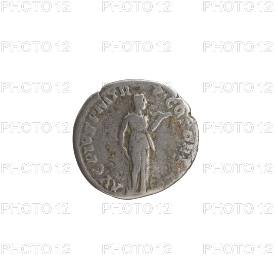 Denarius, Antoninus Pius 86–161; Roman emperor 138–161. Obverse: Head of Antoninus Pius uncovered to the right, legend IMP T AEL CAES HADRI - ANTONINVS. Reverse: Diana standing to the right, holding a bow in her outstretched left hand and an arrow in her lowered right hand, legend AVG PIVS PM TR - P COS DES II. Date: 138. Place of origin: Rome, Roman Empire. Medium/function: coin. Diameter: 16.0–17.0 mm. Weight: 3.31 g. Axis: 195°., A round metallic object with a worn surface and irregular edge showing a faint relief of a standing human figure facing sideways, with one arm extended and the other resting by the side; the object displays areas of discoloration and surface scratches and has tones of silver, gray, and small patches of brownish and greenish tarnish.