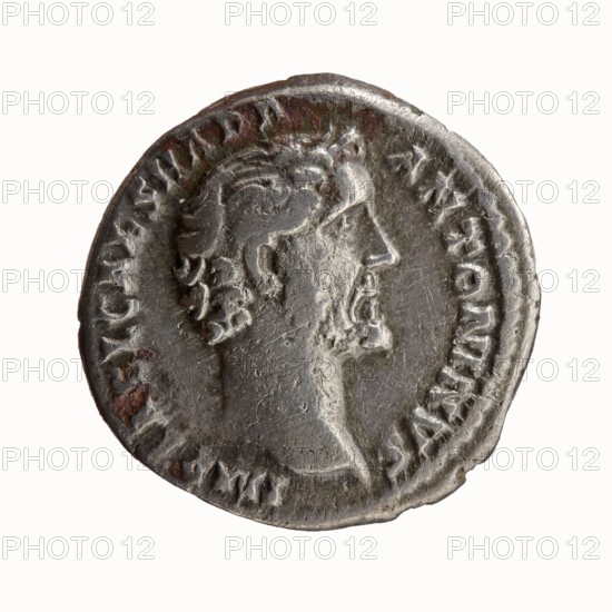 Denarius, Antoninus Pius 86–161; Roman emperor 138–161, issuer. Obverse: head of Antoninus Pius uncovered to the right, legend IMP T AEL CAES HADRI - ANTONINVS all around. Reverse: Felicitas standing left, holding a caduceus in her outstretched right hand and a horn of plenty in her left, legend AVG PIVS PM TR - P COS DES II all around. Iconography: caducei; personifications; horns of plenty; Felicitas standing with a caduceus and a horn of plenty. Date: 138. Place of origin: Rome, Roman Empire 27 BC–476. Type: coin denarius. Dimensions: diameter 16.0–17.0 mm; weight 2.95 g; axis 180°., A round, worn metallic coin with a raised profile of a bearded man facing right, showing textured hair and facial features; the coin surface is primarily silver-gray with areas of darker gray and small patches of brownish discoloration, and a raised rim encircles the portrait with a ring of worn decorative marks around the edge.
