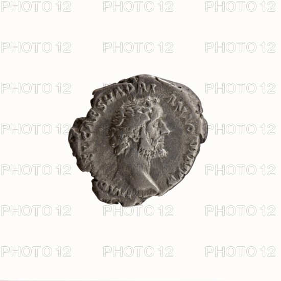 Denarius; obverse: head of Antoninus Pius uncovered to the right, legend IMP T AEL CAES HADRI - ANTONINVS around; reverse: Felicitas standing to the left, holding a caduceus in her outstretched right hand and a cornucopia in her left, legend AVG PIVS PM T - RP COS DES II around; issuer: Antoninus Pius 86–161; Roman emperor 138–161; iconography: personifications, Felicitas, caduceuses, cornucopia; date: 138; place of origin: Rome, Roman Empire; object type: coin denarius; diameter 16.5–18.5 mm; weight 3.03 g; axis 190°, A worn circular metal coin with irregular edges showing a raised profile of a bearded man facing right; the surface is textured with areas of wear and raised rim details, and the visible colors are shades of gray and dark gray.