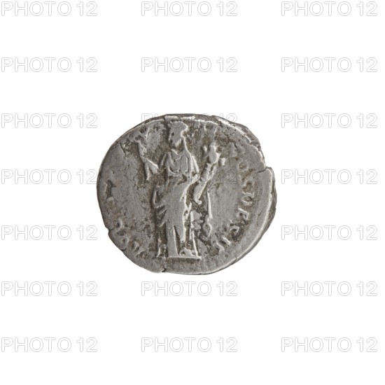 Denarius of Antoninus Pius 86–161; Roman Emperor 138–161. Obverse: Head of Antoninus Pius uncovered to the right; legend IMP T AEL CAES HADRI-ANTONINVS. Reverse: Felicitas standing to the left, holding a caduceus in her outstretched right hand and a cornucopia in her left; legend AVG PIVS PM TRP COS DES II. Iconography: personifications, caduceuses, cornucopias; Felicitas standing with a caduceus and a cornucopia. Date: 138. Place of origin: Rome, Roman Empire. Medium: coin denarius. Dimensions: diameter 15.5–17.0 mm, weight 3.09 g, axis 165°., A worn round coin with an uneven edge showing a raised central figure in relief wearing draped clothing and holding an object, surrounded by a faint ring of worn markings; the coin surface has a textured, aged appearance with areas of darker tarnish and lighter metallic highlights in shades of silver, gray, and dull brown.