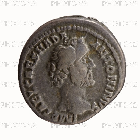 Denarius, Antoninus Pius 86–161; Roman emperor 138–161. Obverse: head of Antoninus Pius bare, right; legend IMP T AEL CAES HADR - ANTONINVS. Reverse: Fortuna standing left, holding a rudder in her right hand and a cornucopia in her left; legend AVG PIVS PM - TR P COS II. Rome, 139. Coin; diameter 17.5–18.0 mm, weight 3.52 g, axis 180°., A round, worn metallic coin with a raised profile of a bearded male figure facing right, surrounded by a raised border and irregular, worn rim; the coin surface shows varied tones of gray with patches of darker gray and subtle brownish discoloration, and the relief and edges display signs of wear and small indentations.