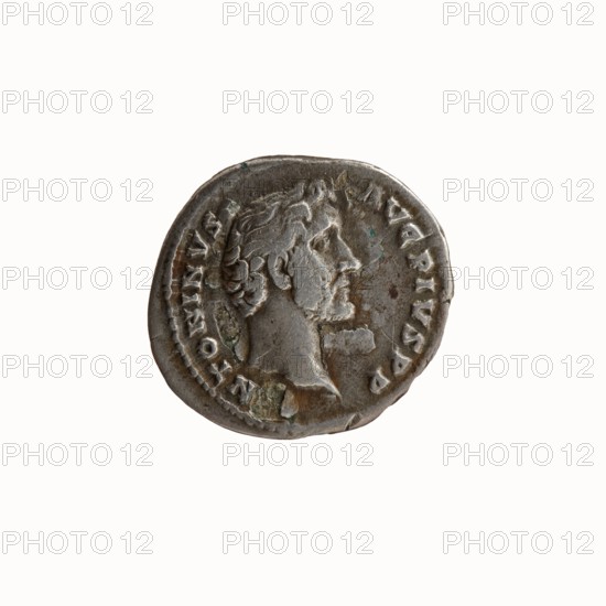 Denarius of Antoninus Pius 86–161; Roman emperor 138–161, struck 139. Obverse: head of Antoninus Pius uncovered to the right, legend ANTONINVS·AVG·PIVS·PP. Reverse: Felicitas standing to the left, holding a caduceus in her outstretched right hand and a cornucopia in her left, legend TR·PO·T·COS·II. Iconography: caduceus, personifications, Felicitas; cornucopia. Roman Empire; Rome mint. Coin, diameter ~17–18 mm, weight 2.86 g, axis 180°., A round metal coin with a worn surface showing a raised profile of a man facing right, surrounded by raised decorative rim and worn raised markings; the coin displays areas of grayish silver metal with patches of darker gray and small greenish discoloration, and a few brownish spots.