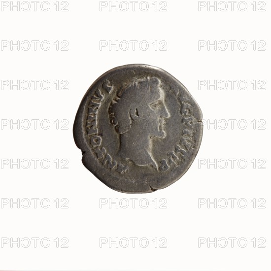 Denarius of Antoninus Pius 86–161; Roman emperor 138–161. Obverse: head of Antoninus Pius bare, right, legend ANTONINVS · AVG · PIVS · PP. Reverse: Fortuna standing left, holding a rudder resting on a globe in her right hand and a cornucopia in her left; legend TR POT · COS II 139. Iconography: personifications, Fortuna, horns of plenty, rudders. Roman, struck at Rome. Coin: diameter ca. 17.5–18.0 mm, weight 2.71 g, axis 180°., A round metal coin with a weathered surface showing a right-facing profile of a person with short hair and a visible ear, surrounded by a raised rim and worn decorative markings along the edge; the coin displays scratches, small dents, and irregularities with a few chipped edges, and the visible colors are shades of gray, dark gray, and muted silver.