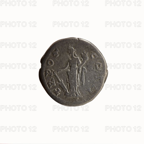 Denarius of Antoninus Pius 86–161; Roman emperor 138–161. Obverse: bare-headed bust of Antoninus Pius right, legend ANTONINVS · AVG · PIVS · PP. Reverse: Fortuna standing left, holding a rudder resting on a globe in her right hand and a cornucopia in her left, legend TR · POT · COS II, dated 139. Iconography: personifications Fortuna, horns of plenty, rudders. Minted in Rome, Roman Empire. Coin; diameter 17.5–18.0 mm, weight 2.71 g, axis 180°., A round, dark gray coin with a worn surface showing a raised, central figure of a standing person holding an object in one hand and a staff-like shape in the other, surrounded by a few shallow marks and decorative shapes around the edge; the coin's edge is slightly irregular with a small notch, and the visible colors are dark gray with lighter gray highlights from wear.