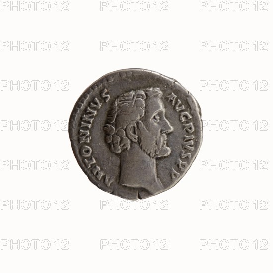 Denarius of Antoninus Pius 86–161; Roman emperor 138–161. Obverse: bare head of Antoninus Pius to right, legend ANTONINVS • AVG • PIVS • PP. Reverse: Fortuna standing left, holding a rudder in her right hand and a cornucopia in her left, legend T • R POT • COS II; dated 139, Rome. Roman Empire 27 BC–476. Coin; diameter 17.0–17.5 mm, weight 3.22 g, axis 180°., A round metallic object with a worn gray surface showing a raised profile of a bearded male facing right, with detailed hair and facial features, set against a smooth background; the edge of the object is slightly irregular and shows a rim with shallow impressions, and the overall colors visible are shades of gray and silver.