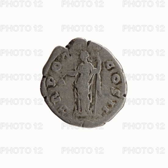 Denarius of Antoninus Pius 86–161; Roman emperor 138–161. Obverse: head of Antoninus Pius bare, right; legend ANTONINVS·AVG·PIVS·PP. Reverse: Libertas standing left, holding a liberty cap pileus in right hand and a long staff vindicta in left; legend TR·POT·COS·II. Date: 139, mint: Rome. Type: Roman coin; diameter c. 17.5–18.0 mm, weight 2.76 g, axis 165°. Iconography: personification of Liberty Libertas with pileus and vindicta; attributes and inscriptions as described., A worn round object with an irregular edge, appearing metallic and primarily grey, placed against a white background; the object shows the faint raised outline of a standing human figure in the center with a few small raised shapes around the perimeter and a group of circular and curved impressions near the edges.