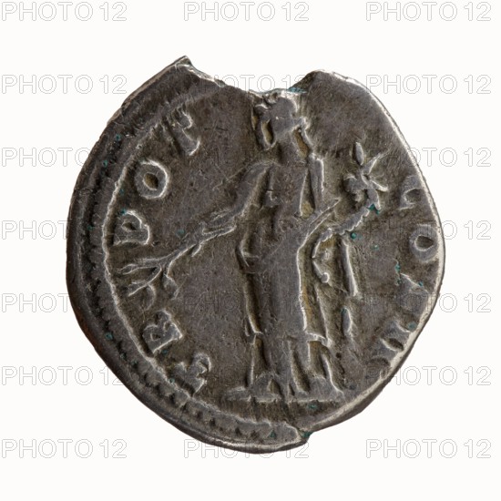 Denarius, Antoninus Pius 86–161; Roman emperor 138–161. Obverse: Head of Antoninus Pius uncovered to the right, legend ANTONINVS AVG PIVS PP. Reverse: Pax standing left, holding a twig in his right hand and a cornucopia in his left, legend TR POT COS II. Iconography: Pax, personification, horns of plenty. Issuer: Antoninus Pius. Date: 139. Place: Rome, Roman Empire. Object type/material: Coin denarius. Measurements: diameter 17.0–17.5 mm, weight 2.88 g, axis 180°., A worn circular metal coin with a dark gray surface and hints of greenish-blue corrosion showing along its edges and recesses, featuring a raised relief of a standing human figure draped in a long garment holding a branch-like object, surrounded by a raised rim and faint decorative marks around the perimeter, with irregularities and small chips along the outer edge and subtle variations in the metal's sheen.