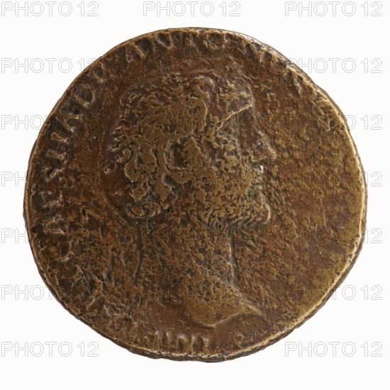 Sestertius of Antoninus Pius 86–161; Roman emperor 138–161. Obverse: bare-headed bust of Antoninus Pius to right, legend IMP T AEL CAES HADRI ANTONINVS AVG PIVS. Reverse: Annona standing left; in her right hand she holds two ears of corn above a modius filled with grain, in her left hand she holds a cornucopia above the stern of a ship; legend P M TR P POT COS II with SC in fields. Iconography: personifications, ears of corn, ships, modius, cornucopias; Annona standing with ears of corn above a modius. Roman, 139 CE. Coin: bronze sestertius; diameter 30.5–31.0 mm, weight 24.05 g, axis 180°., A worn round metal object with a textured, uneven surface showing a profile of a head in low relief; the object displays a patina of brown and dark brown with areas of lighter golden-brown highlights and small greenish spots; the edge is slightly irregular and the surface has pitted and mottled patterns across a few raised and recessed areas.