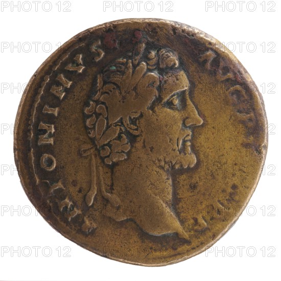 Sestertius, Antoninus Pius 86–161; Roman emperor 138–161. Issuer: Antoninus Pius. Obverse: head of Antoninus Pius in a laurel wreath facing right; inscription ANTONINVS · AVG PIVS PP. Reverse: Felicitas standing frontally, head facing left, holding a caduceus in his outstretched right hand and a horn of plenty in his left; inscription T RPO · T COSII in SC. Legend: 139. Roman Empire, Rome. Coin; diameter 32.0–32.5 mm; weight 23.96 g; axis 180°., A circular metal object with worn edges showing a raised profile of a bearded man facing right, wearing a wreath with leaf and ribbon details; the surface shows areas of smooth wear and pitting with visible darker spots and greenish corrosion; the overall color is a mix of dull gold, brown, and darker bronze tones, with subtle highlights where the relief is more pronounced.