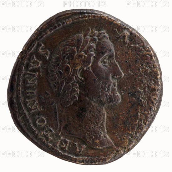 Sestertius of Antoninus Pius 86–161; Roman Emperor 138–161. Obverse: head of Antoninus Pius in a laurel wreath facing right; inscription ANTONINVS AVG PIVS PP. Reverse: Fides standing frontally, head facing right, holding a bowl of fruit in his outstretched left hand and ears of corn in his lowered right hand; legend TR POT - C - OS II, in SC. Minted Rome, 139. Bronze coin; diameter ~31–32 mm, weight 23.99 g, axis 330°., A round, worn metal coin with a raised profile of a bearded man facing right, showing detailed hair and a laurel wreath; the coin surface is textured and pitted with areas of smooth wear; colors visible include dark brown, reddish-brown, greenish-brown, and lighter brown highlights; the coin edge shows a beaded border and irregular rim with worn spots; a faint suggestion of raised decorative elements surrounds the portrait.