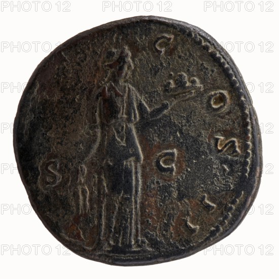 Sestertius of Antoninus Pius 86–161; Roman Emperor 138–161. Obverse: head of Antoninus Pius in a laurel wreath facing right; legend ANTONINVS·AVG·PIVS·PP. Reverse: Fides standing frontally, head facing right, holding a bowl of fruit in his outstretched left hand and ears of corn in his lowered right hand; legends TR POT·C·OS II and SC. Date: 139. Roman coin, struck in Rome. Diameter c. 31–32 mm; weight 23.99 g; axis 330°., A round, aged coin with a dark brown and black patina shows a worn raised figure of a standing person draped in a long garment holding a small crown-like object in one hand, with the rim of the coin featuring a dotted border and the surface marked by textured wear and patches of lighter brown and greenish tones.