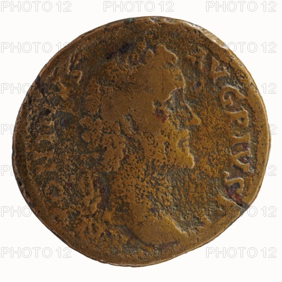 Sestertius of Antoninus Pius 86–161; Roman Emperor 138–161. Obverse: head of Antoninus Pius in a laurel wreath facing right, legend ANTONINVS · AVG · PIVS · PP. Reverse: Fides standing frontally, head facing right, holding a bowl of fruit in his outstretched left hand and ears of corn in his lowered right hand, legend TR POT - C OS II, in the fields SC. 139. Iconography: ears of corn, fruit; personification Fides Fidelity. Roman Empire, Rome. Coin; diameter 31.5–34.0 mm; weight 22.37 g; axis 195°., A worn round metal coin with an uneven surface showing a profile of a person's head in low relief; the coin displays a mottled mix of brown, dark brown, and hints of reddish and greenish patina across its face, with areas of smoother and rougher texture and a slightly irregular, dented rim.