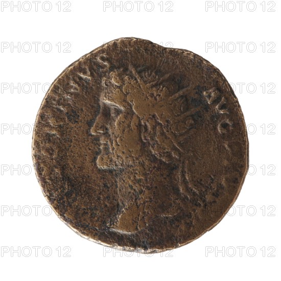 Dupondius; Antoninus Pius 86–161; Roman Emperor 138–161 — issuer. Obverse: head of Antoninus Pius in radiant crown left; legend ANTONINVS · AVG · PIVS · PP. Reverse: Fides standing frontally, head turned right, left hand outstretched holding a bowl of fruit, right hand lowered holding ears of corn; legends TR · POT · COS II and SC in fields. Date: 139. Roman Empire; Rome mint. Coin bronze, diameter 27.0 mm, weight 12.74 g, axis 330°., A worn round metal coin with a raised profile of a person facing left; the surface shows rough texture and pitting with areas of smoother relief. The coin displays a mix of brown and dark brown tones with some blackish spots and slightly lighter golden-brown highlights on raised areas. The edge is irregular and slightly worn, and the background behind the coin is white.