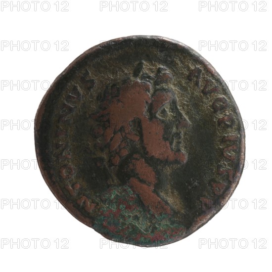 Obverse: Head of Antoninus Pius in a laurel wreath facing right, legend ANTONINVS · AVG · PIVS · PP. Reverse: Genius standing left, holding a patera above a burning altar in his right hand and a cornucopia in his left, legend TR POT · COS II, in SC; dated 139. Roman Imperial coin; diameter 27.5 mm, weight 11.04 g, axis 195°. Maker: Antoninus Pius 86–161; Roman Emperor 138–161., A round metal object with a worn relief of a human profile facing right, showing textured hair and facial features; the surface has areas of dark brown, reddish-brown, greenish patina, and traces of darker gray, with uneven corrosion and pitting around the edges.