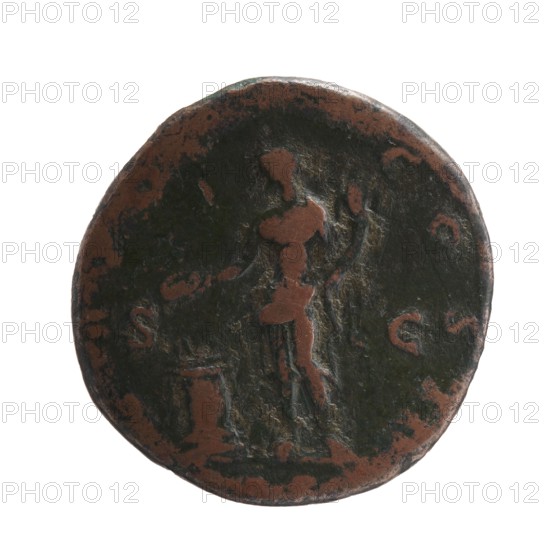 Antoninus Pius 86–161; Roman Emperor 138–161. Obverse: Head of Antoninus Pius in a laurel wreath facing right, legend ANTONINVS · AVG · PIVS · PP. Reverse: Genius standing left, right hand holding a patera above a burning altar, left hand holding a cornucopia, legend TR · POT · COS · II around, in exergue S C; dated 139. Roman Imperial bronze coin; diameter 27.5 mm, weight 11.04 g, axis 195°., A circular, worn metal object with a dark greenish-black patina and areas of exposed brown metal, showing an indented relief of a standing human figure in the center and a few raised shapes and irregular marks around the edges. The figure and surrounding areas show mixed tones of dark green-black and brown, with lighter brown highlights where the surface is worn. The edge is uneven and the surface has a textured, aged appearance.