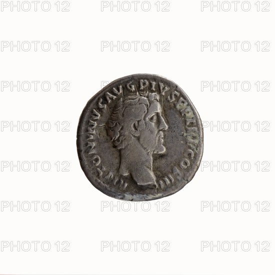 Denarius, Antoninus Pius 86–161; Roman emperor 138–161 issued by Marcus Aurelius 121–180; Roman emperor 161–180 caesar 139–161. Obverse: Head of Antoninus Pius without a cap to the right, legend ANTONINVS AVG PIVS PP TR P COS III. Reverse: Bust of young Marcus Aurelius without a cap, wearing a cloak paludamentum, facing right, legend AVRELIVS CAESAR AVG PII F COS. Date: 140. Place of origin: Rome, Roman Empire. Coin; diameter 16.5–17.5 mm, weight 3.38 g, axis 345°., A circular metallic coin with a worn surface showing a raised profile of a man's head facing right, surrounded by a raised border and a ring of worn raised markings; the coin's colors are shades of gray, silver, and dark gray with some darker tarnished areas.