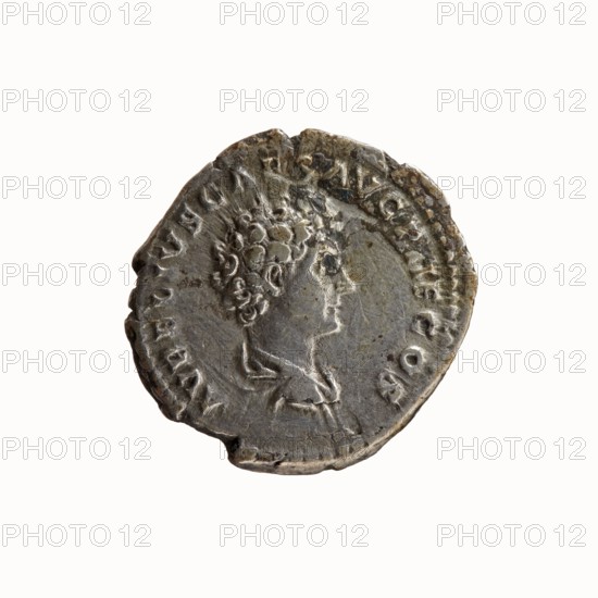 Denarius, Antoninus Pius 86–161; Roman emperor 138–161 issuer; Marcus Aurelius 121–180; Roman emperor 161–180 caesar 139–161; heir to the throne 138–161 — iconography: paludamentums, heads portraits. Obverse: Head of Antoninus Pius without a cap to the right, legend ANTONINVS AVG PIVS - PP TR P COS III around. Reverse: Bust of young Marcus Aurelius in cloak paludamentum, without headgear, right, legend AVRELIVS CAES - AVG PII F COS all around. Date: 140. Place of origin: Rome, Roman Empire. Object type: coin denarius. Dimensions: diam. 17.0 mm, diam. 18.5 mm; weight 3.27 g; axis 195°., A round metal coin with a worn surface showing a raised profile of a person's head facing right, curly hair, and a draped neckline, with a textured rim and irregular edge; visible colors include grey, silver, dark brown, and hints of black and greenish tarnish.
