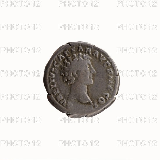 Denarius, Antoninus Pius 86–161; Roman emperor 138–161. Obverse: Head of Antoninus Pius with laurel wreath to the right, legend ANTONINVS AVG PI - VS PP TR P COS III around. Reverse: Head of young Marcus Aurelius without a covering to the right, legend AVRELIVS CAESAR AVG PII F COS around. Dated 140. Roman Empire, Rome. Coin; silver; diameter 17.0–17.5 mm; weight 3.18 g; axis 210°., A round metallic coin with a worn surface showing a raised profile of a person facing right, featuring curly hair and a visible neck and shoulder; the coin has an irregular edge with small chips and indentations and a textured rim with raised decorative elements; the colors visible are shades of gray and darker gray with slight brownish patina.