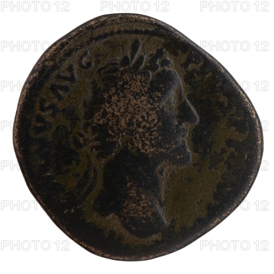 Sestertius of Antoninus Pius 86–161; Roman emperor 138–161. Obverse: Head of Antoninus Pius in a laurel wreath facing right, legend ANTONINVS AVG - PIVS PP IMP II. Reverse: Securitas seated left on a chair formed of crossed cornucopias, holding a scepter in his right hand and resting his left elbow on the chair, legend TR POT XX - COS IIII, in fields SC. Date: 156–157. Roman Empire; Rome. Coin: diameter ca. 31.0–32.5 mm, weight 26.60 g, axis 0°., A round, worn coin with a dark brown and black patina showing areas of lighter brown where the surface is abraded; a raised profile of a person facing right is visible in the center with textured hair and a laurel or leafy crown, and the rim of the coin shows irregular wear and a few rough spots.