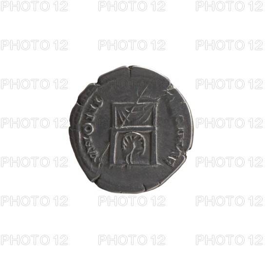 Denarius, Antoninus Pius 86–161; Roman emperor 138–161, issuer; Faustina the Elder 98–141; Roman empress 138–141, co-creator. Obverse: Bust of Faustina I in drapery facing right; legend FAVSTINA · AVGVSTA. Reverse: Throne of Juno pulvinar covered with drapery; beneath it a peacock with tail spread, a scepter rests on the left; legend IVNONI · REGINAE. Date: 139–141. Place of origin: Rome, Roman Empire. Medium: coin denarius. Dimensions: diameter 16.5–17.0 mm; weight 3.10 g; axis 180°., A round metallic object with a dark gray surface sits against a white background; its edge is irregular with a few small chips, and the face shows a carved rectangular design divided into two stacked sections, the upper section containing a diagonal motif and the lower section showing a curved, fan-like shape; the surface has slight scratches and worn areas, and the visible colors are dark gray and white.