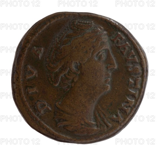 Sestertius, posthumous issue for Faustina the Elder 98–141; Roman empress 138–141; issuer: Antoninus Pius 86–161; Roman emperor 138–161. Obverse: bust of Faustina I in drapery facing right, legend DIVA · FAVSTINA. Reverse: Juno veiled, standing left, right hand outstretched, holding a scepter in left; legend AETERNITAS in SC fields. Issued after 141, Roman Empire, Rome. Coin: diameter 29.5–30.5 mm, weight 27.73 g, axis 0°., A circular metal coin with a worn profile of a person's head facing right, showing facial features, hair styled with waves and a small crown or headdress, and a suggestion of clothing at the neck; the coin surface is aged and pitted with a mottled patina in shades of brown and darker brown with hints of green, and the rim shows irregularities and raised edging.