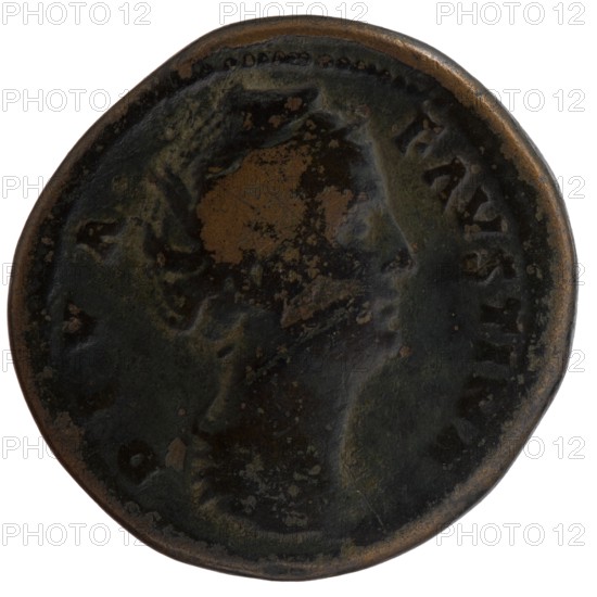 Sestertius, posthumous issue for Faustina the Elder 98–141; Roman empress 138–141; issuer: Antoninus Pius 86–161; Roman emperor 138–161. Obverse: Bust of Faustina I draped, facing right, legend D IVA - FAVSTINA around. Reverse: Ceres in a veil standing left, holding two short torches in her raised hands, legend AVGVSTA around, in SC. Struck after 141, Roman Empire; Rome mint. Bronze coin, diameter 32.5 mm, weight 28.40 g, axis 345°., A round, worn metal coin with a dark brown and greenish patina showing areas of lighter brown where the surface is more polished or corroded; the coin displays the raised profile of a person's head in the center with worn facial and hair details, and a slightly raised rim around the edge.