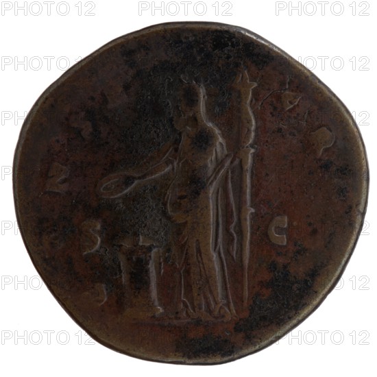 Sestertius, Faustina the Elder 98–141; Roman empress 138–141 posthumous, Antoninus Pius 86–161; Roman emperor 138–161 issuer. Bust of Faustina I in drapery facing right; legend: A - FAVSTINA around. Reverse: Vesta standing left, holding a patera in her outstretched right hand above an altar and a long scepter in her left. Legend: C ONSE - CRATIO all around; in SC. fields. After 141, Rome; Roman Empire. Coin; diameter 31.5–33.0 mm; weight 22.65 g; axis 180°., A round, worn coin with a dark brown and black patina showing a standing figure in relief holding a long staff and a shallow dish, with the figure draped in flowing garments and a small raised object nearby; the coin edge is irregular and the surface shows areas of darker spotting and lighter brown highlights.