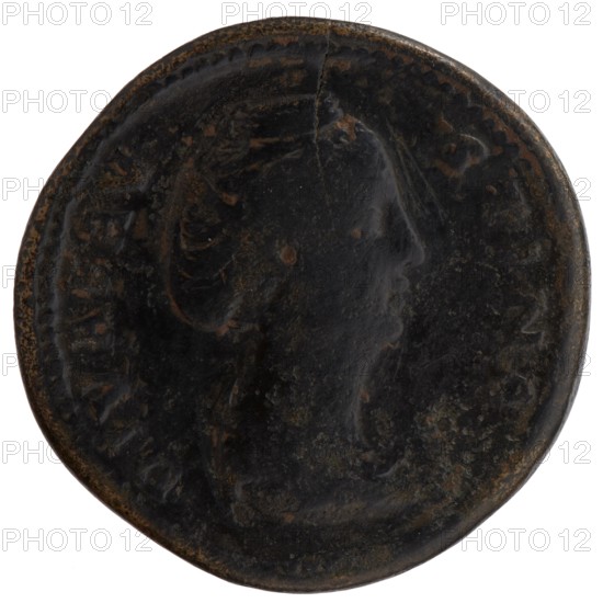 Sestertius, Faustina the Elder 98–141; Roman empress 138–141 posthumous, Antoninus Pius 86–161; Roman emperor 138–161 issuer. Draped bust of Faustina I facing right, legend DIVA FAVSTINA all around; reverse: Vesta standing left, in her outstretched right hand she holds a patera above an altar, in her left a long scepter; legend C ONS E C R ATIO in exergue and in SC. fields. After 141, Rome, Roman Empire. Bronze coin; diameter 32.5–33.0 mm, weight 29.55 g, axis 180°., A round, worn coin with a raised profile of a person's head facing right, showing a forehead, nose, lips, chin, and part of an ear; the coin surface is dark with areas of brownish corrosion and lighter worn spots, and the rim shows a beaded edge in places with irregular patina and scratches.
